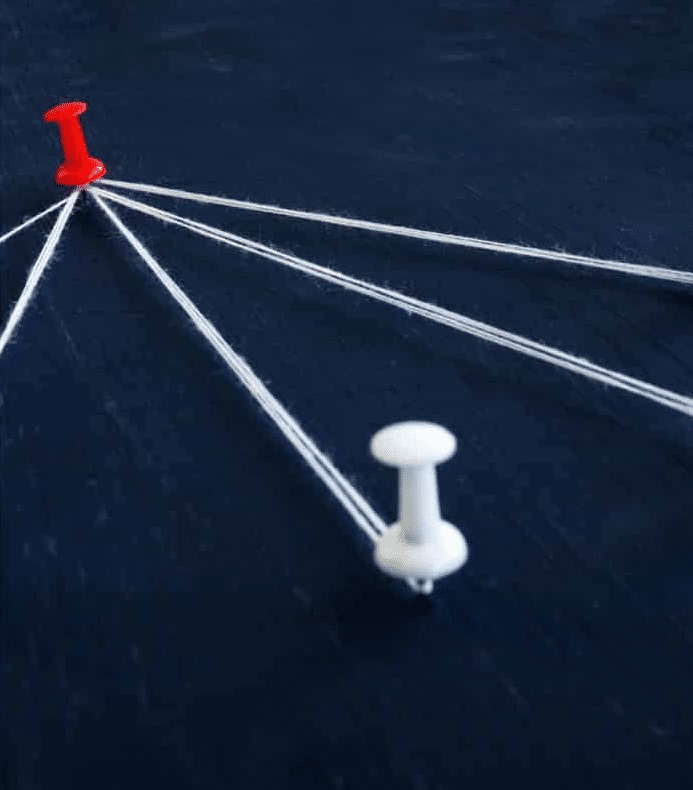 A conceptual close-up of a red pushpin on a dark surface acting as a central hub, with multiple white strings radiating outward to other pins.