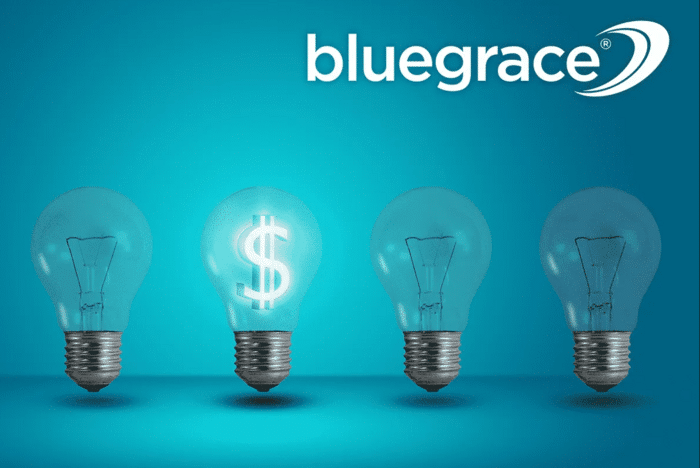 A conceptual graphic for BlueGrace Logistics featuring four light bulbs in a row against a teal background; one bulb is brightly illuminated with a glowing dollar sign inside, symbolizing cost-saving ideas.