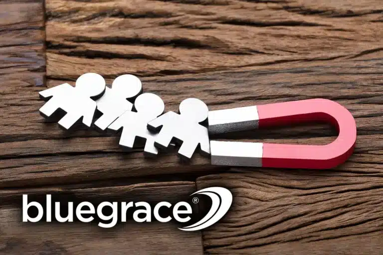 A conceptual image showing a red horseshoe magnet attracting several small silver human figures on a rustic wooden surface, accompanied by the BlueGrace logo.