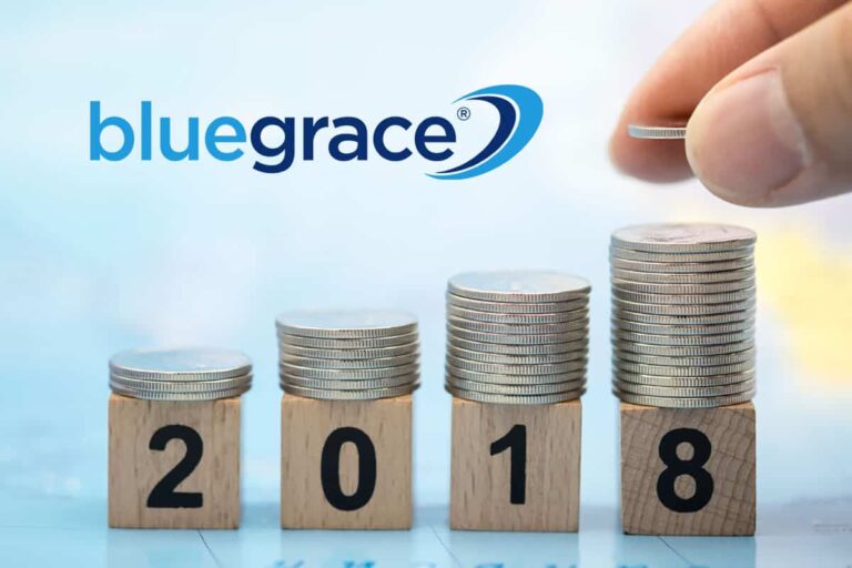 Stacked coins on wooden blocks labeled 2018 with the BlueGrace logo and a hand adding a coin.
