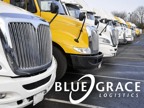 Row of parked commercial semi-trucks lined up in a fleet yard