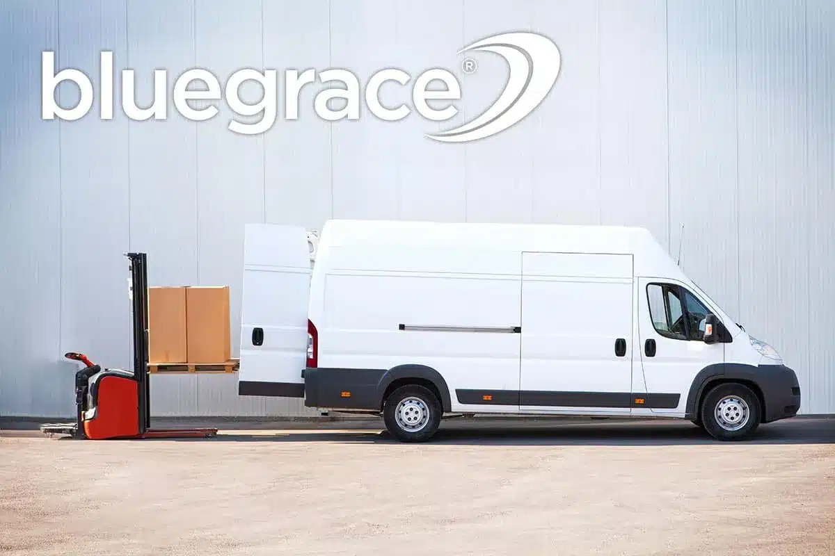 Electric forklift loading cardboard boxes into the back of a white delivery van with BlueGrace logo.