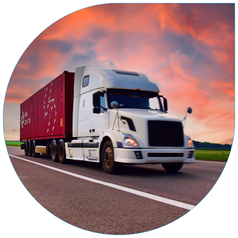 Heavy-duty freight truck carrying a red shipping container on an open road, highlighting efficient intermodal transport solutions.