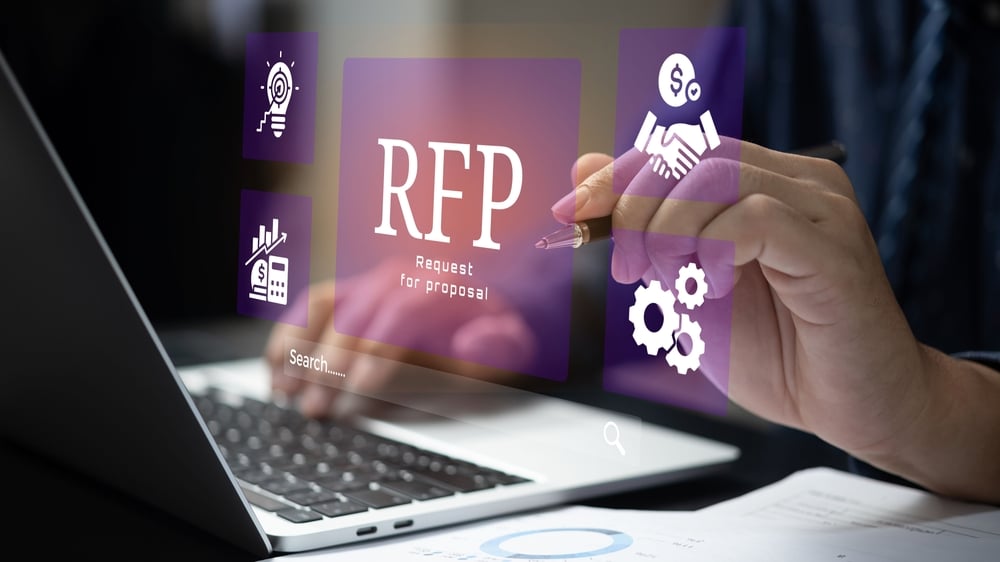 person using laptop pointing at RFP graphic