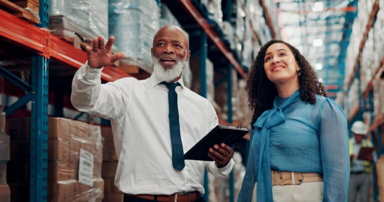 Black man and Black woman working in a freight warehouse with logistics operations