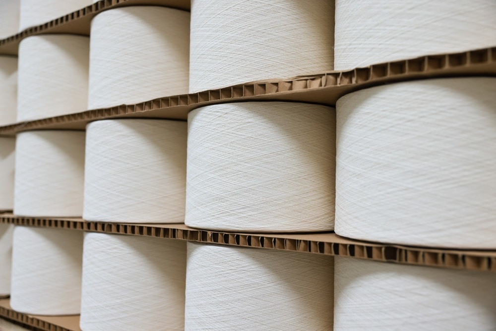 stacks of white cotton and polyester textiles