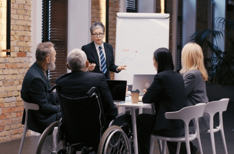 Business team sits at table discussing corporate strategy during meeting