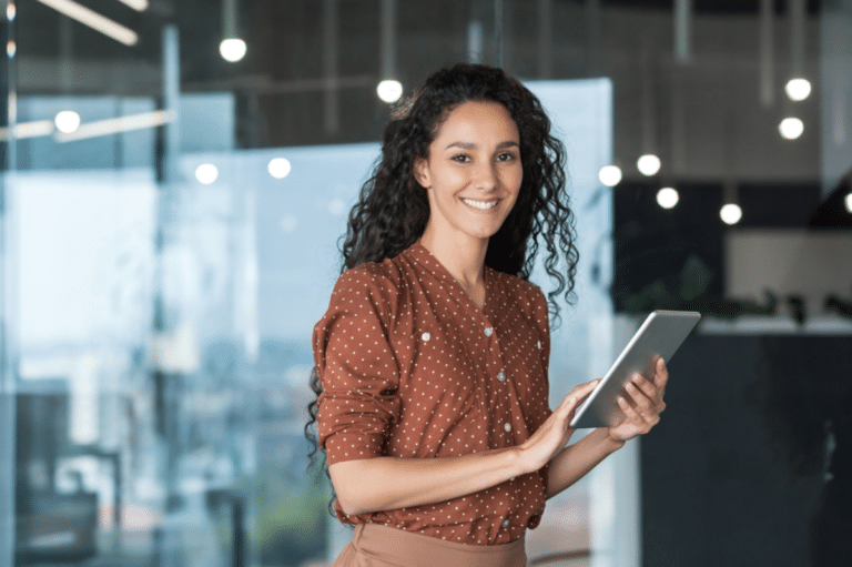 young successful female smiling holding tablet computer